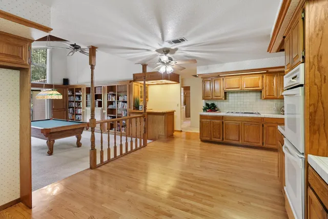 a kitchen with stainless steel appliances granite countertop a sink and dishwasher with wooden floor