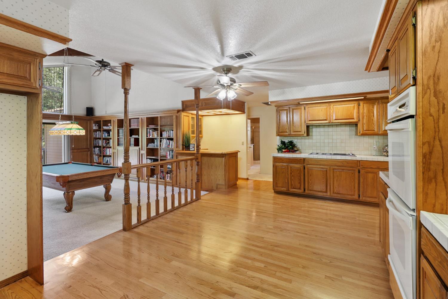 6798 Terreno Drive Rancho Murieta, CA 95683 - Photo 23 of 63 a kitchen with stainless steel appliances granite countertop a sink a stove and a refrigerator
