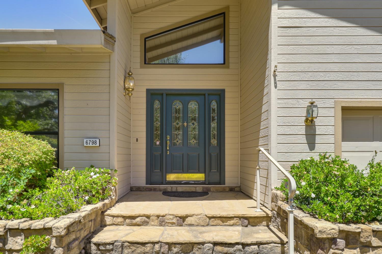 6798 Terreno Drive Rancho Murieta, CA 95683 - Photo 3 of 63 a view of a brick house with potted plants