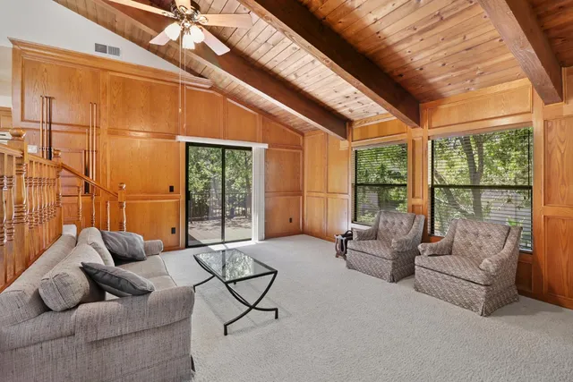 an empty room with windows and cabinet