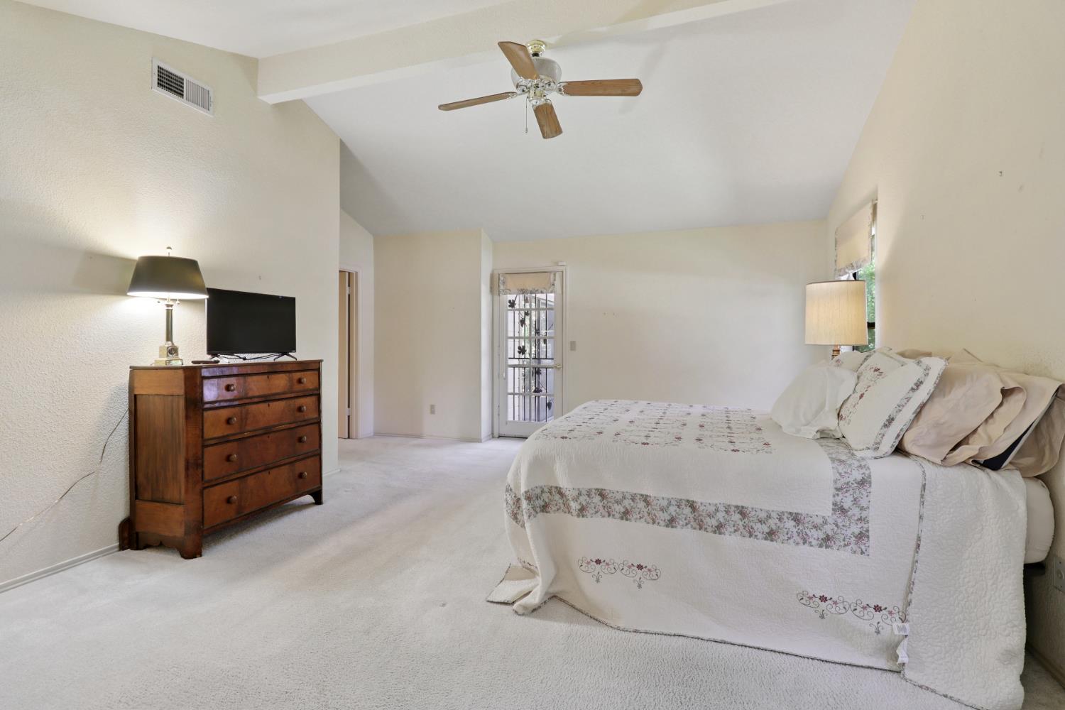 6798 Terreno Drive Rancho Murieta, CA 95683 - Photo 39 of 63 a bedroom with a bed and a tv on the dresser