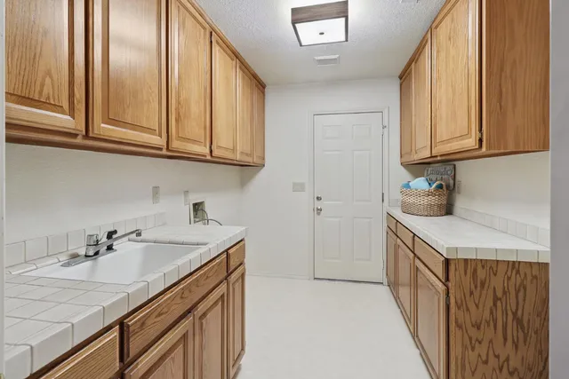 a yellow house with tree in front of it