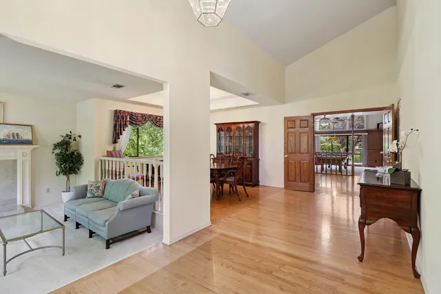 a dining room with furniture a chandelier and wooden floor