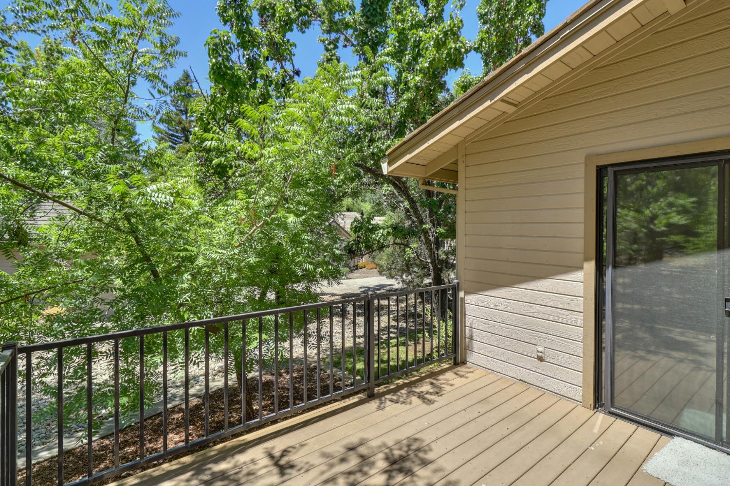 6798 Terreno Drive Rancho Murieta, CA 95683 - Photo 60 of 63 a view of a wooden balcony and trees