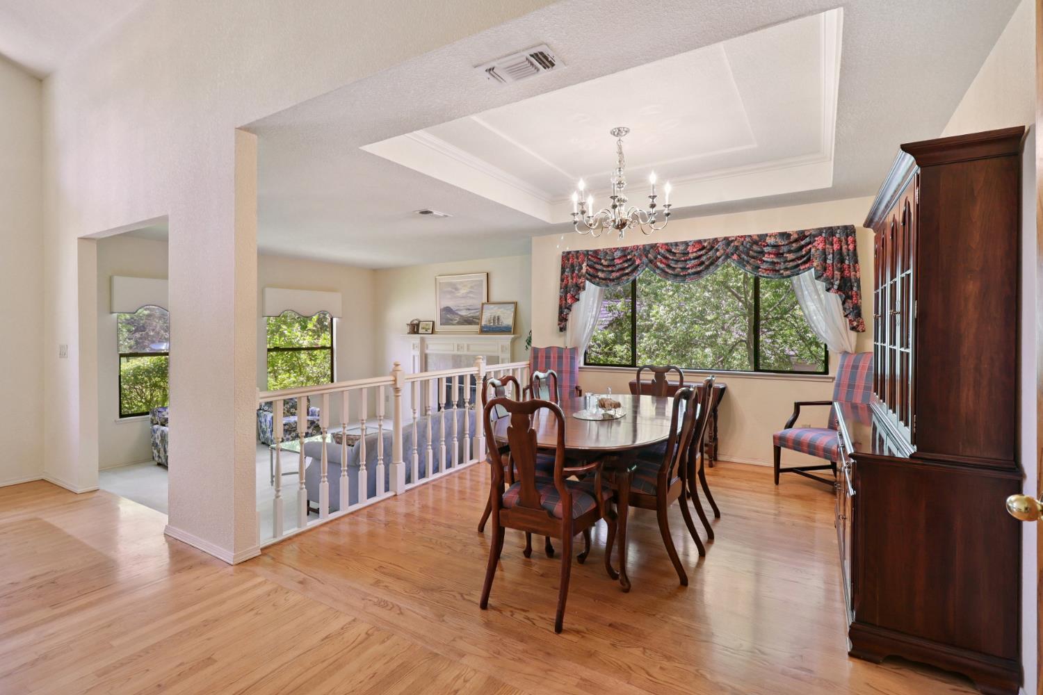 6798 Terreno Drive Rancho Murieta, CA 95683 - Photo 6 of 63 a dining room with furniture a chandelier and wooden floor