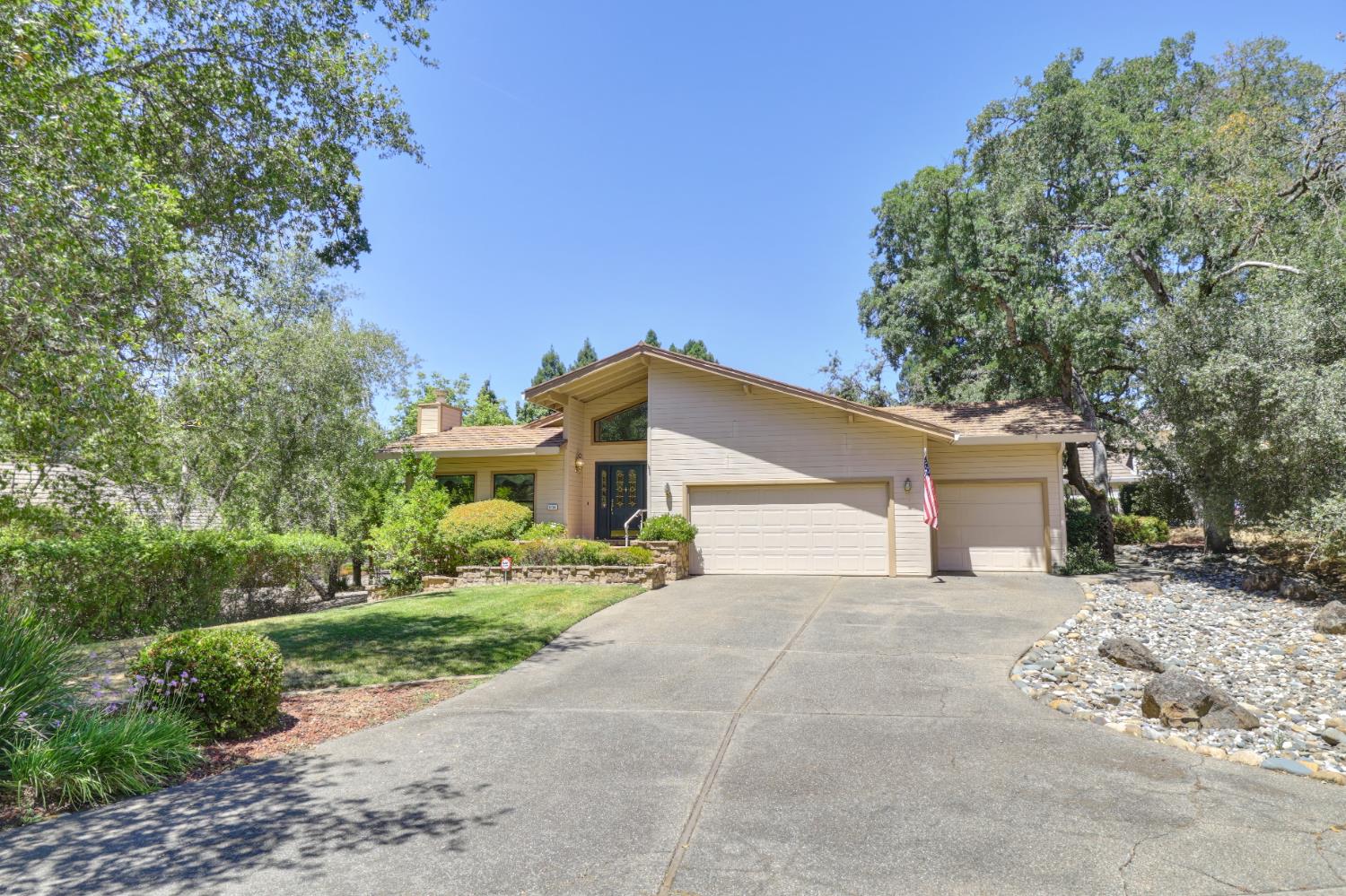 6798 Terreno Drive Rancho Murieta, CA 95683 - Photo 63 of 63 a front view of a house with a yard and garage