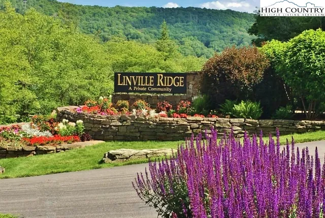 a view of a sign board with wooden fence