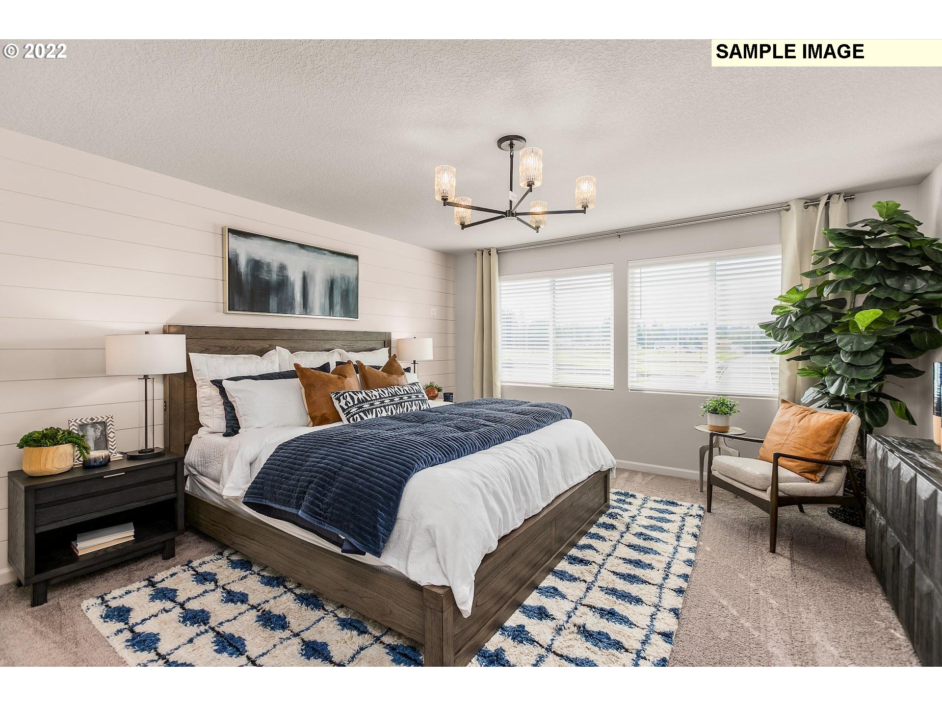 37413 Coho Street Sandy, OR 97055 - Photo 15 of 23 a bedroom with a bed and a chandelier
