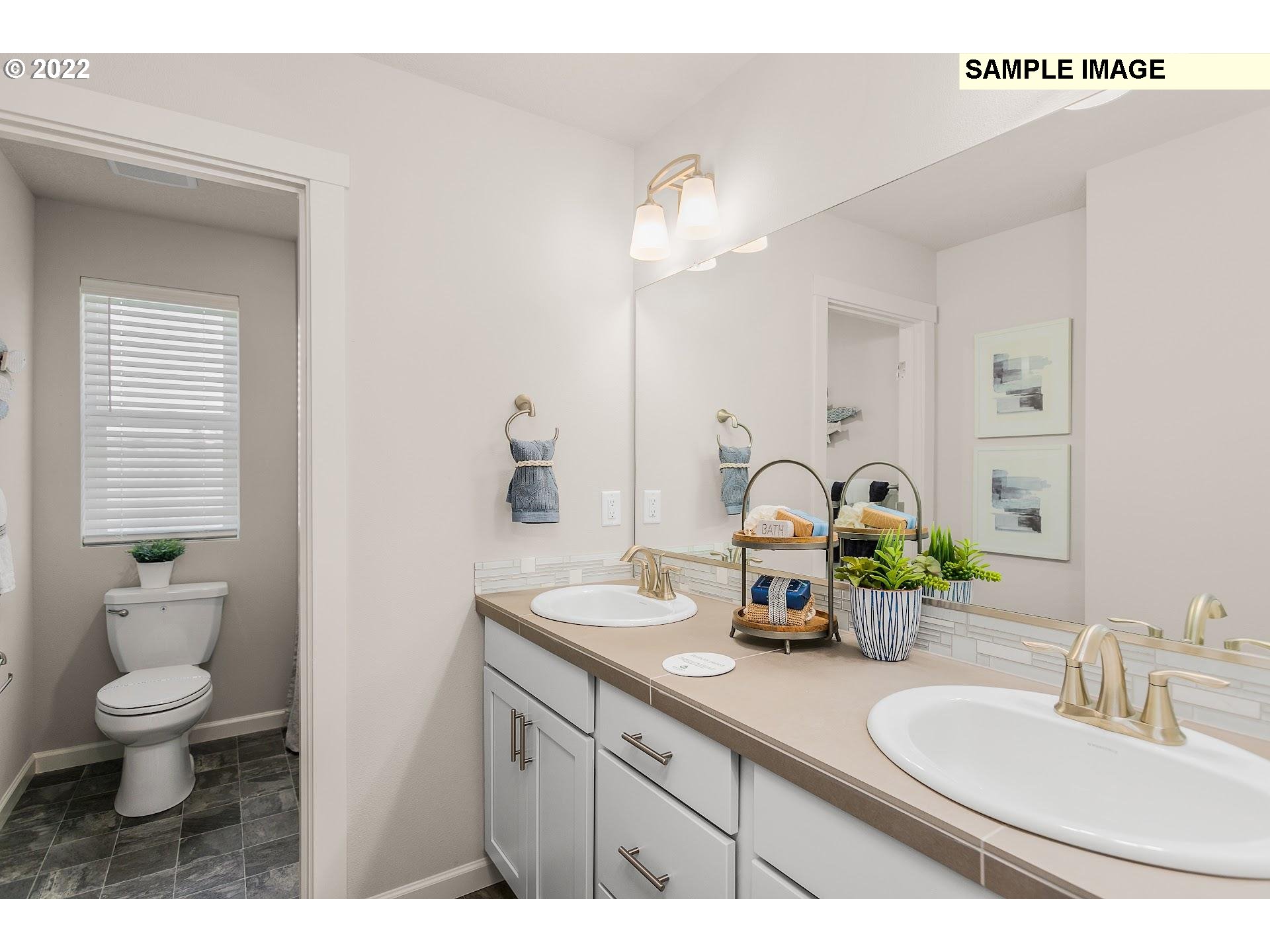 37413 Coho Street Sandy, OR 97055 - Photo 21 of 23 a bathroom with a double vanity sink and a toilet