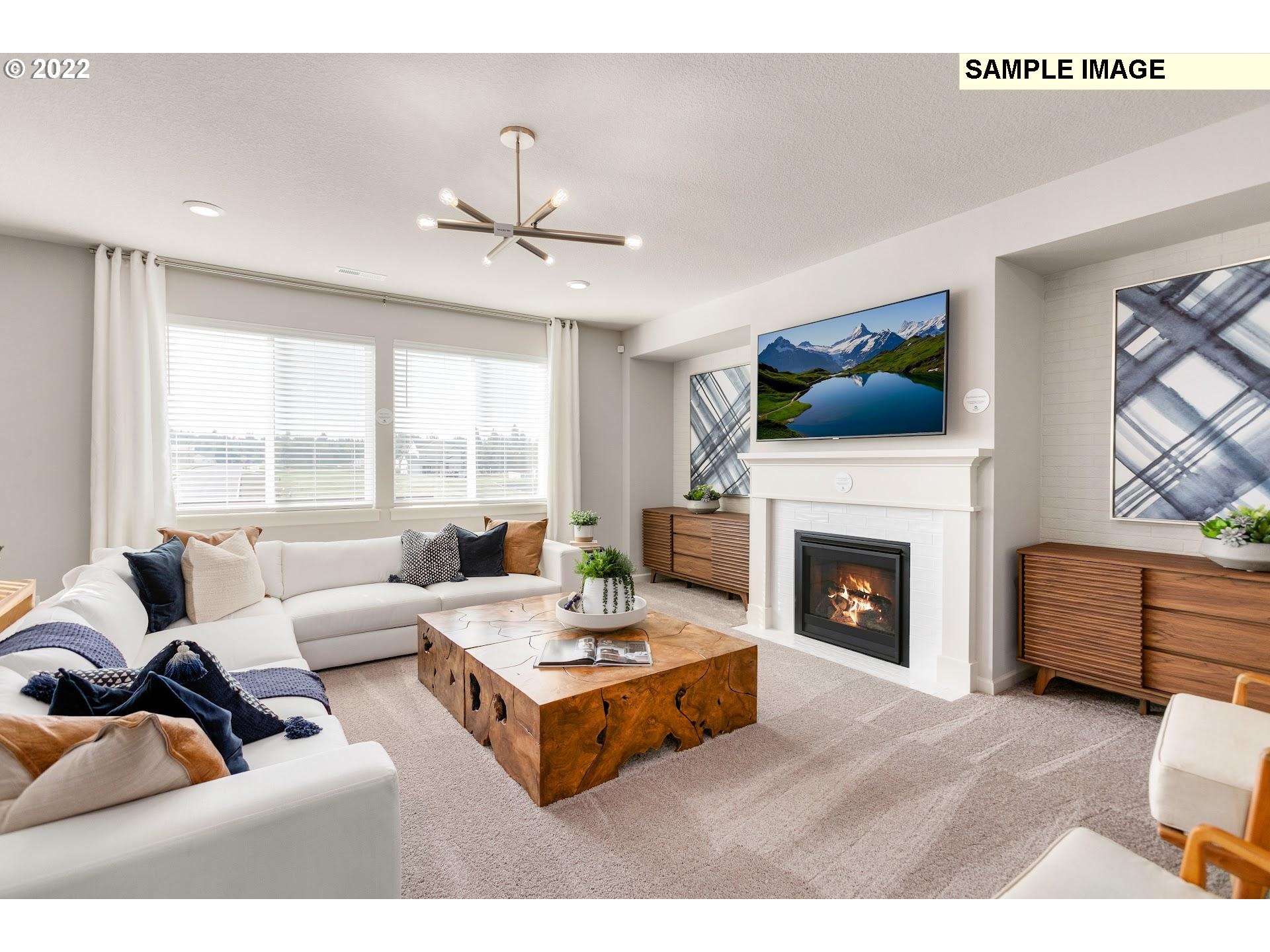 37413 Coho Street Sandy, OR 97055 - Photo 5 of 23 a living room with furniture a fireplace and a flat screen tv