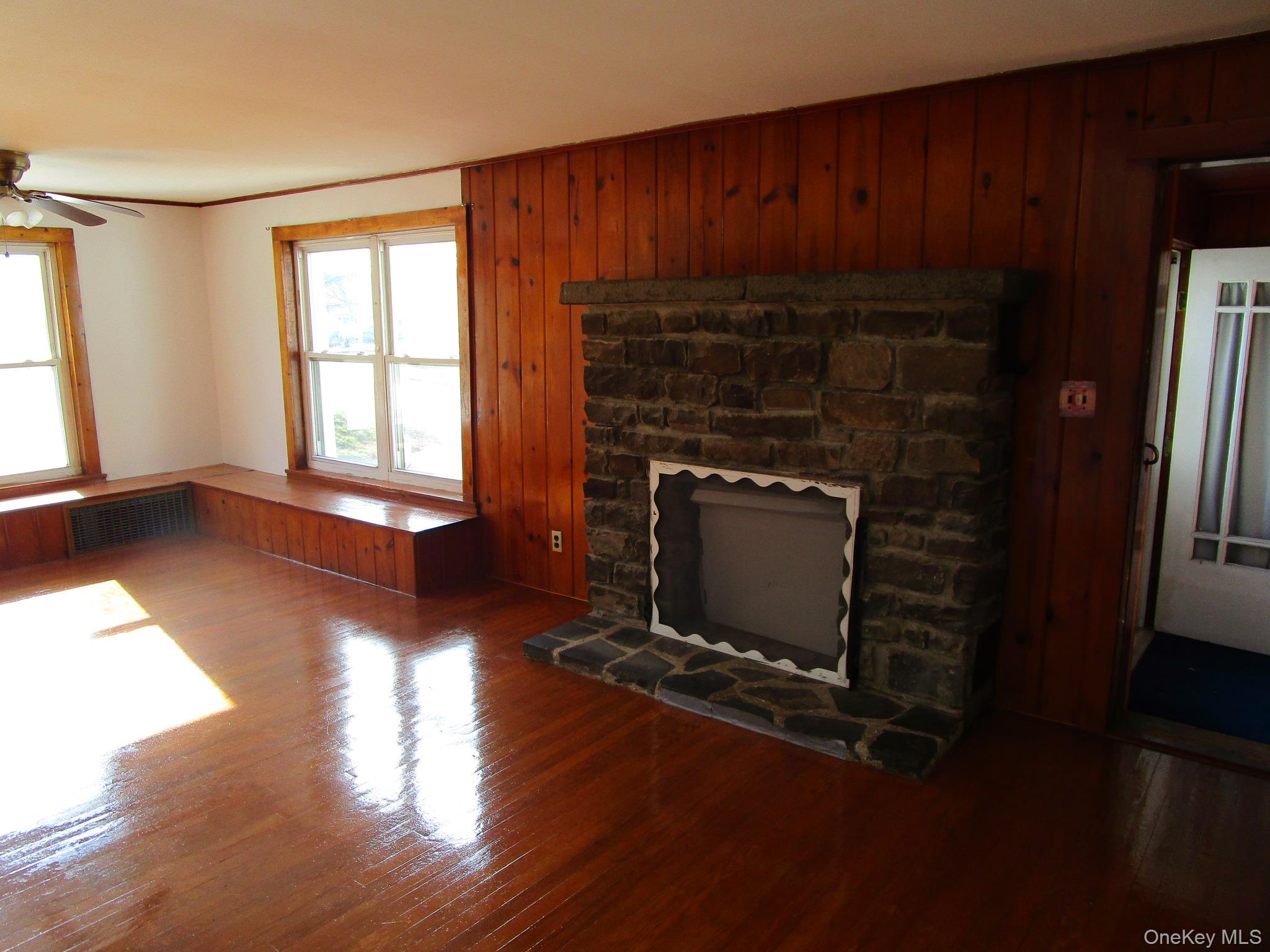 36 Bert Crawford Road Middletown, NY 10940 - Photo 5 of 23 an empty room with wooden floor fireplace and windows