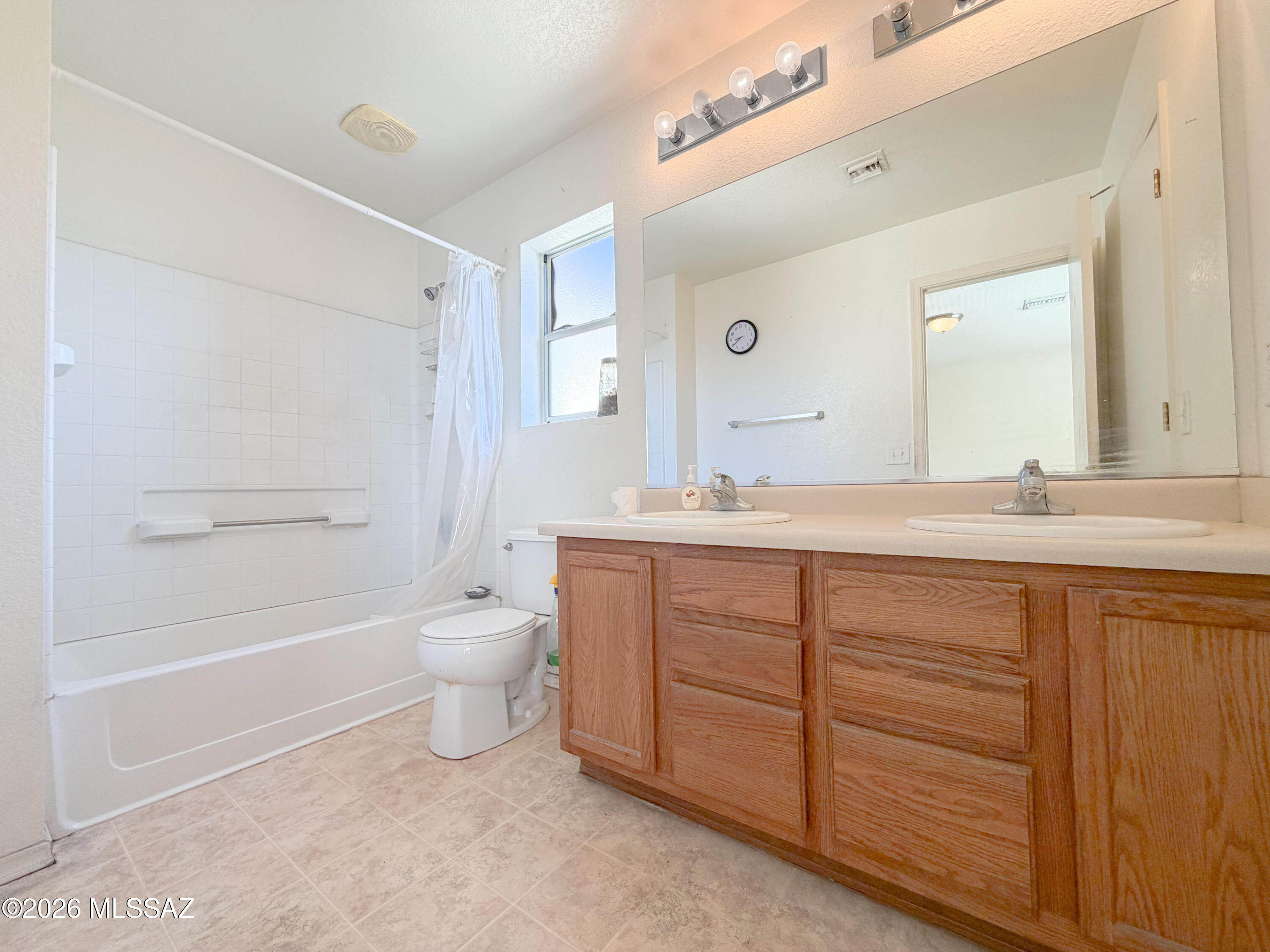 5779 South Manta Ray Road Tucson, AZ 85706 - Photo 12 of 30 a bathroom with a granite countertop sink a toilet and a bathtub