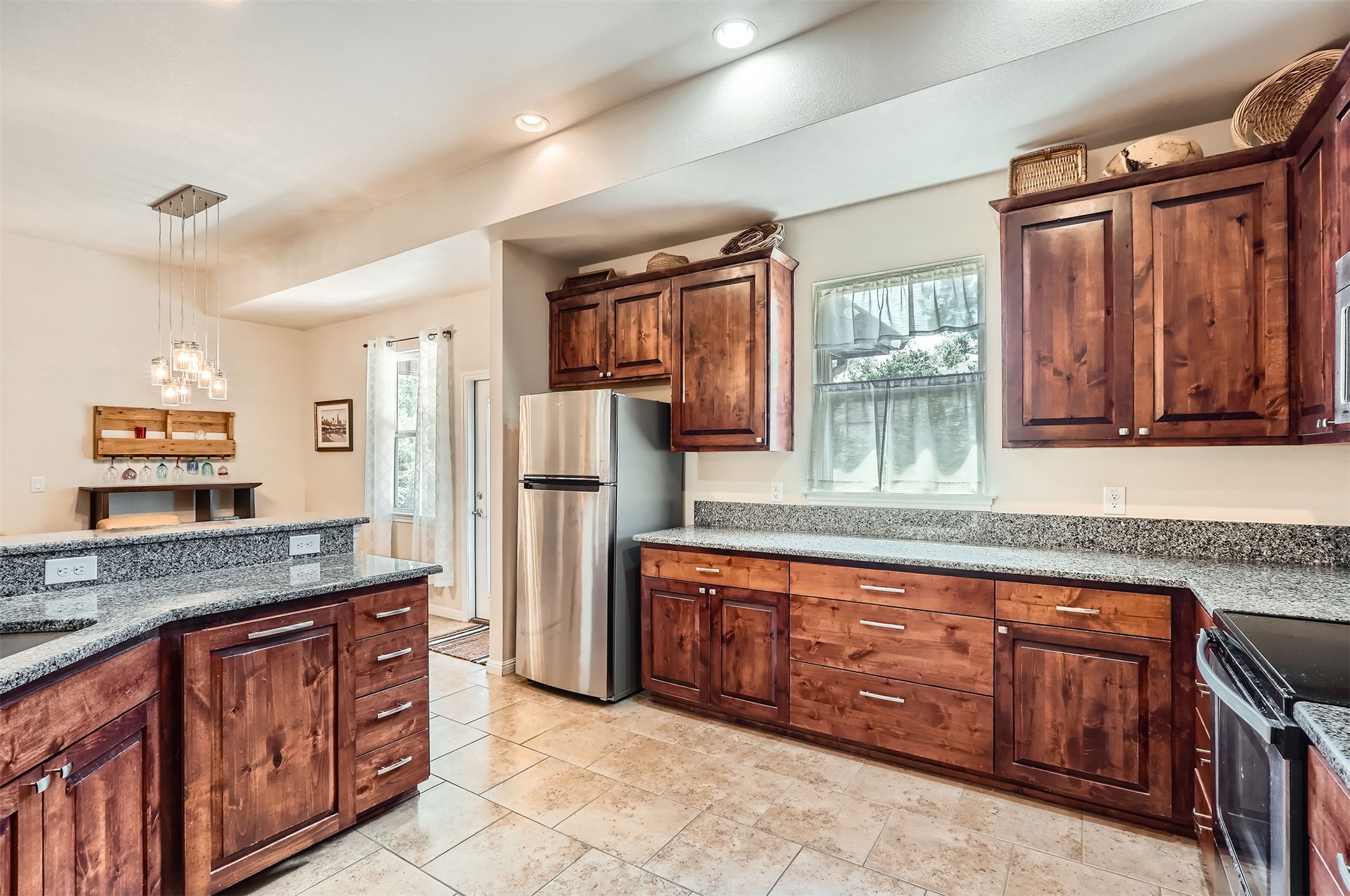 5501 Hitching Post Lago Vista, TX 78645 - Photo 10 of 26 a kitchen with stainless steel appliances granite countertop a refrigerator and a sink