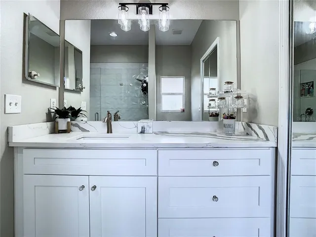 a bathroom with a sink double vanity and mirror
