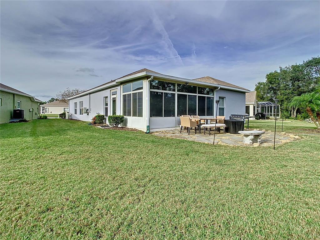 2841 Banyan Hill Lane Land O' Lakes, FL 34639 - Photo 20 of 20 a front view of house with a garden and patio