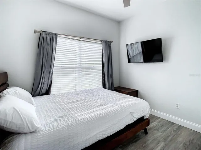 a bedroom with a bed and a flat screen tv