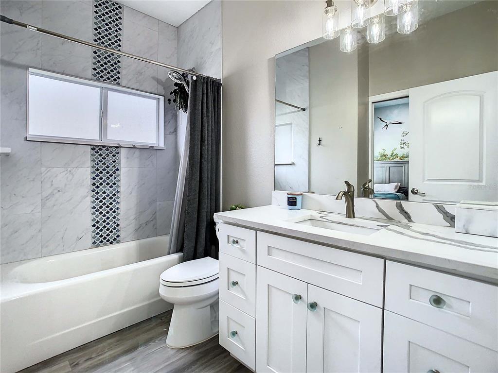 2841 Banyan Hill Lane Land O' Lakes, FL 34639 - Photo 6 of 20 a bathroom with a granite countertop sink toilet and shower