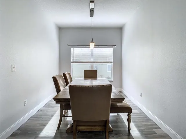 a dining room with furniture and wooden floor