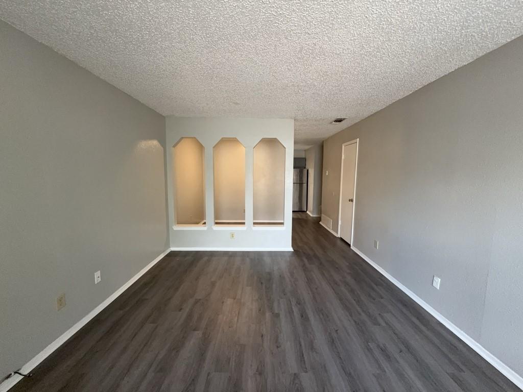 219 Fry Street, Unit 6 Denton, TX 76201 - Photo 3 of 13 a view of room with wooden floor