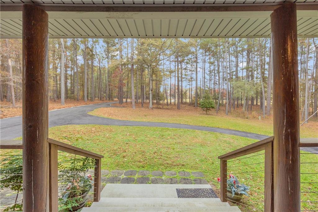 2885 Callie Still Road Lawrenceville, GA 30045 - Photo 18 of 79 a view of a room with wooden floor and a floor to ceiling window