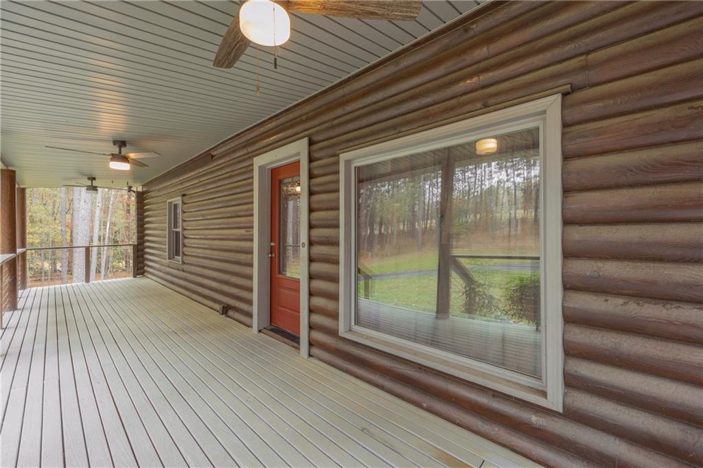 2885 Callie Still Road Lawrenceville, GA 30045 - Photo 19 of 79 a view of a porch with wooden floor and floor to ceiling window