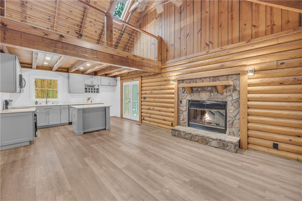 2885 Callie Still Road Lawrenceville, GA 30045 - Photo 23 of 79 a living room with stainless steel appliances wooden floors and fireplace