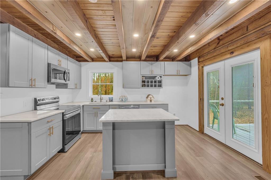 2885 Callie Still Road Lawrenceville, GA 30045 - Photo 27 of 79 a kitchen with a stove sink and cabinets