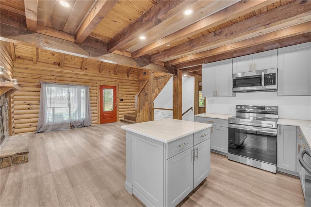 2885 Callie Still Road Lawrenceville, GA 30045 - Photo 29 of 79 a kitchen that has a lot of cabinets in it and stainless steel appliances