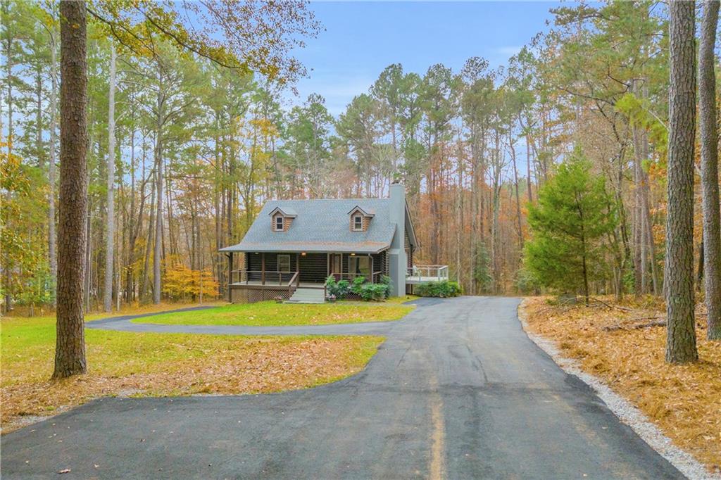 2885 Callie Still Road Lawrenceville, GA 30045 - Photo 3 of 79 a front view of a house with a yard and trees