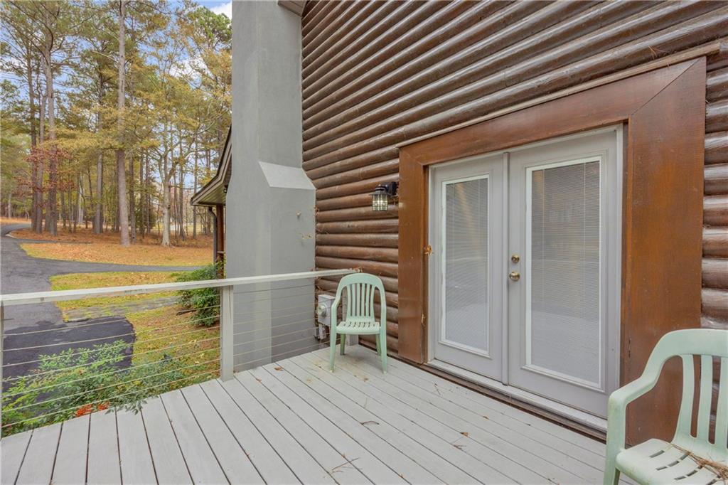 2885 Callie Still Road Lawrenceville, GA 30045 - Photo 33 of 79 a view of a balcony with wooden floor and outdoor seating
