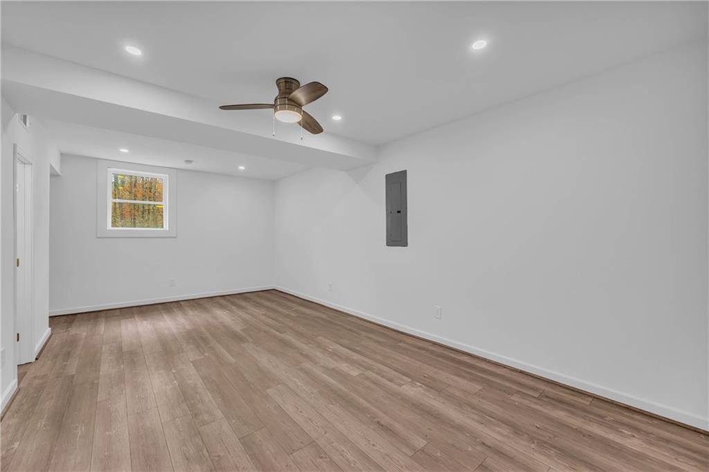 2885 Callie Still Road Lawrenceville, GA 30045 - Photo 40 of 79 a view of an empty room with a window and wooden floor