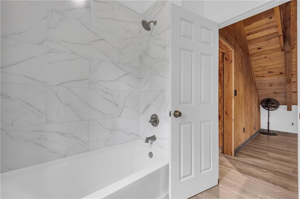 2885 Callie Still Road Lawrenceville, GA 30045 - Photo 60 of 79 a bathroom with bathtub and shower