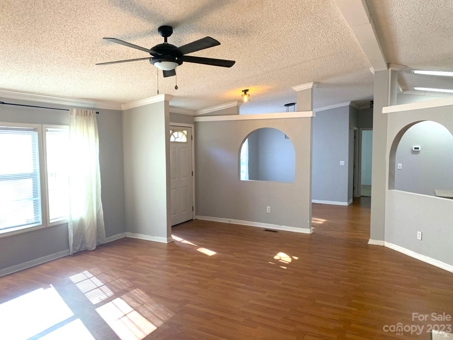 1864 Coopers Gap Road Rutherfordton, NC 28139 - Photo 12 of 46 a view of a livingroom with a ceiling fan window and wooden floor