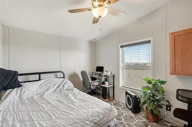 a bedroom with a bed and potted plant