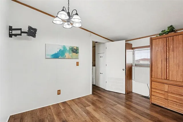 a view of a room with wooden floor and a window