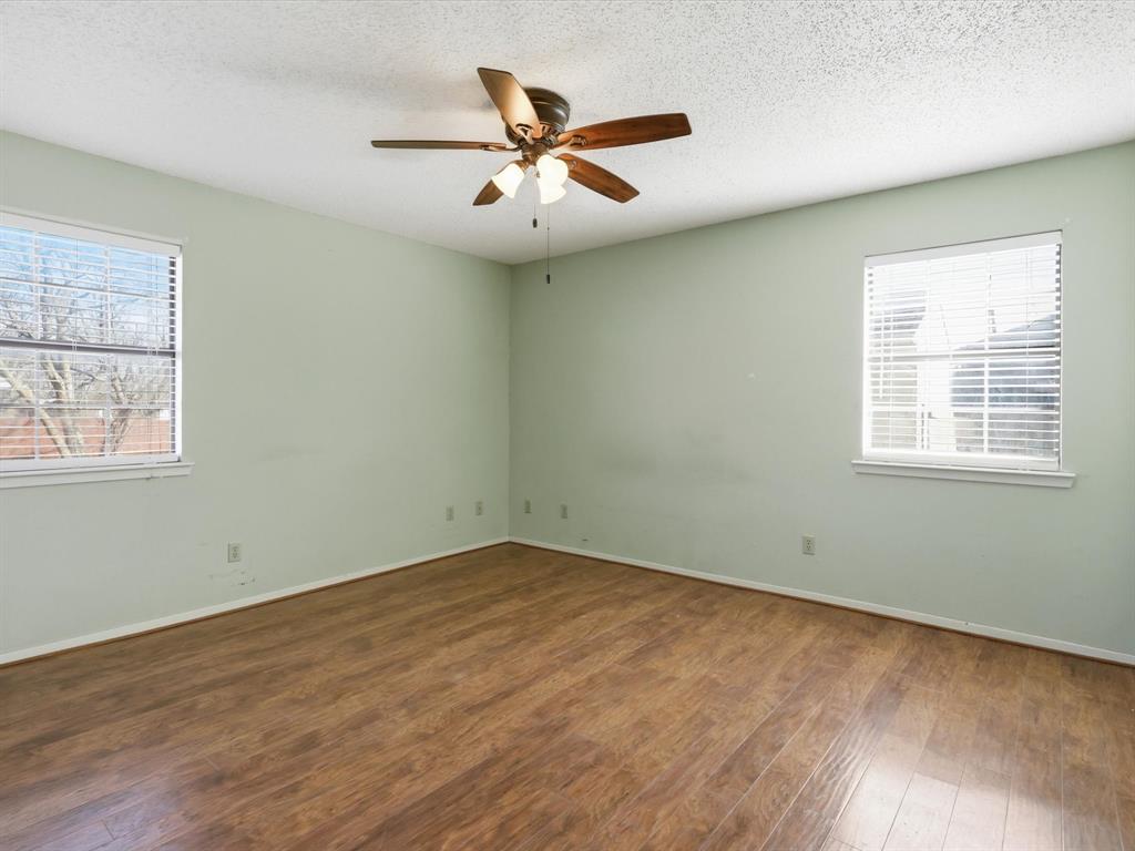 701 College Street Celeste, TX 75423 - Photo 16 of 29 wooden floor in an empty room with a window