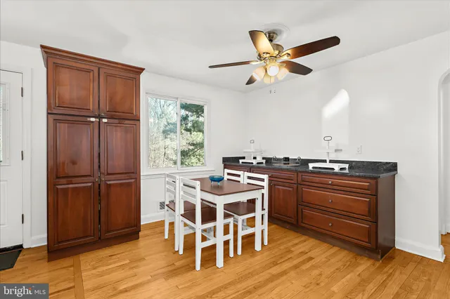 a view of a workspace with furniture and a window