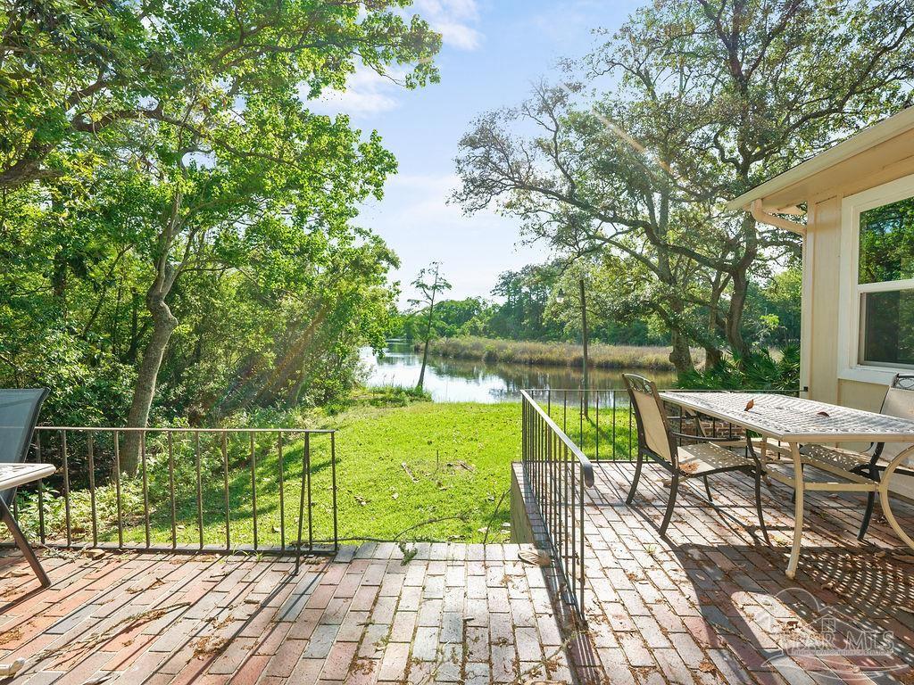 609 Dog Track Road Pensacola, FL 32506 - Photo 2 of 22 a view of a chair and tables on the patio