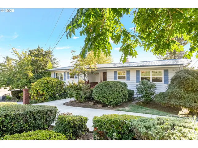 a front view of a house with a garden