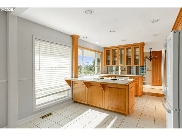a large bathroom with a tub a sink and large window