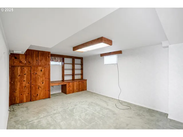 a view of a hallway with wooden floor and entryway