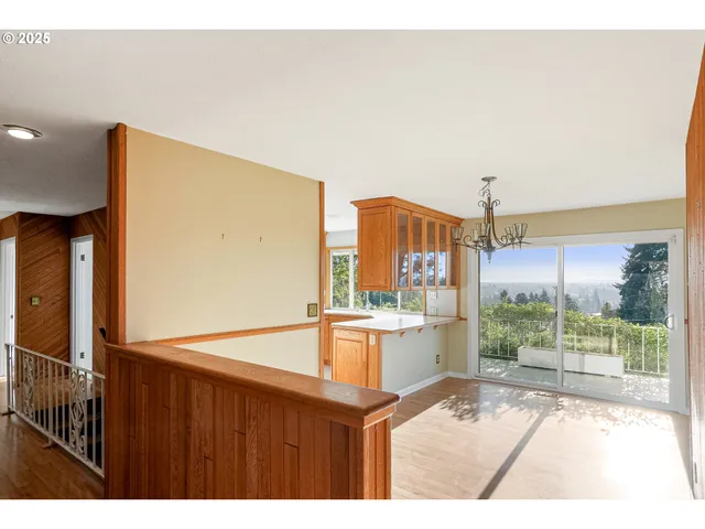 a kitchen view with wooden floor and a large window