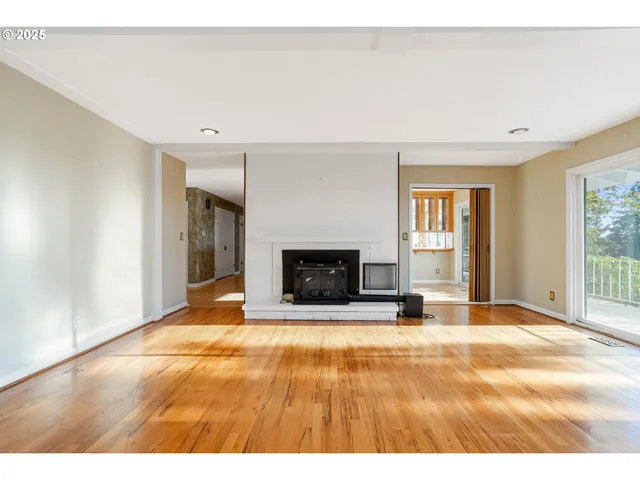 a view of an empty room with a fireplace