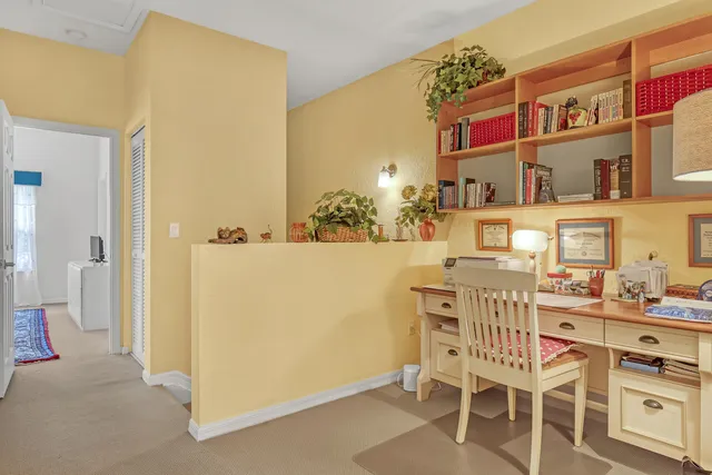 a dining room with furniture and a kitchen view
