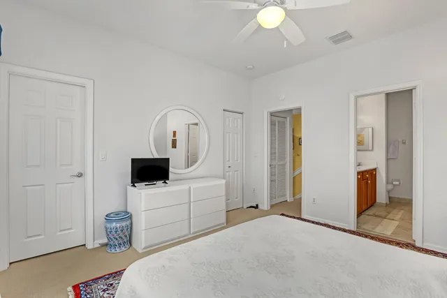 a bedroom with a bed and a view of en suite bathroom