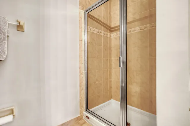 a bathroom with a glass shower door