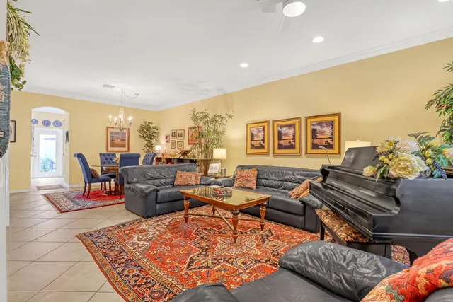 a living room with furniture a rug and a flat screen tv