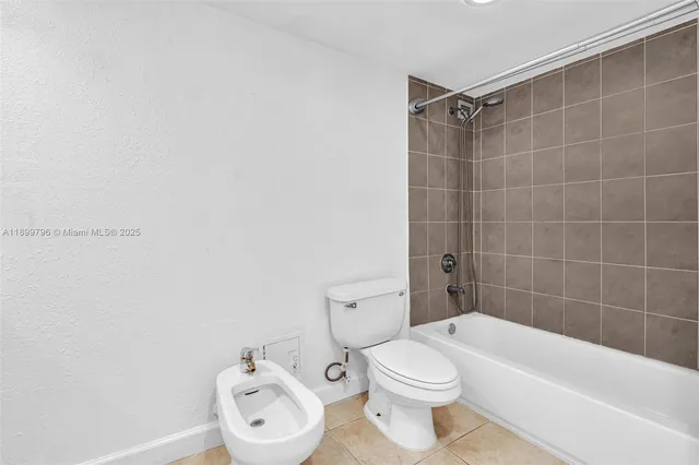 a bathroom with a toilet a sink and bathtub