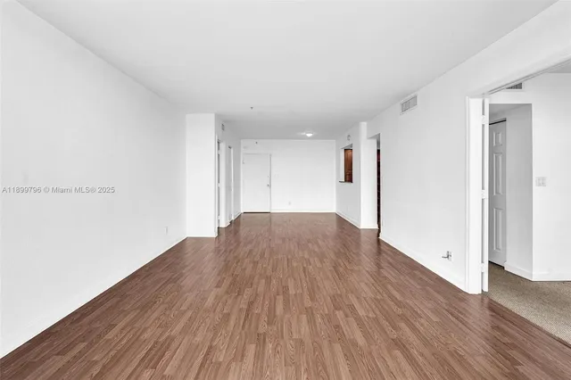 a view of a room with wooden floor