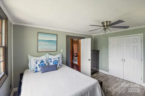 a bedroom with a large bed and a chandelier